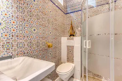 a bathroom with a shower and a toilet and a tub at Ryad Mogador Liège in Liège