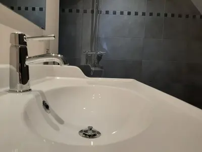 a white sink with a faucet in a bathroom at Peaceful Peer Holiday Home in Peer