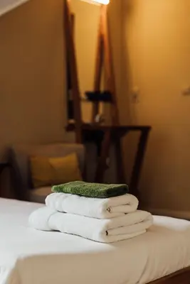 a pile of towels sitting on top of a bed at De Zwarte Stok in Riemst
