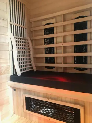 a room with a fireplace with two white chairs at Burgemeesterhuys in Beringen