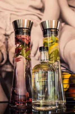 three bottles of alcohol sitting on a table at Burgemeesterhuys in Beringen