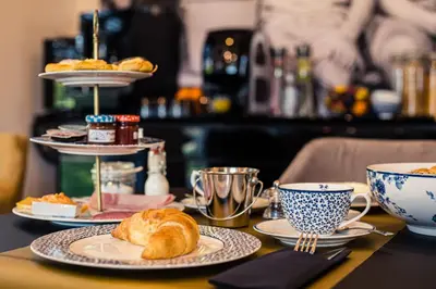 a table with plates of croissants and cups of coffee at Burgemeesterhuys in Beringen