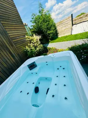 a hot tub in the backyard of a house at Les gîtes de Bouxhmont in Herve