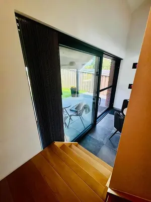 a room with a bed and a view of a patio at Les gîtes de Bouxhmont in Herve