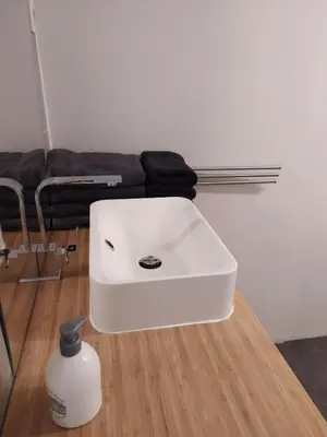 a white sink sitting on top of a wooden floor at The Place in Lommel
