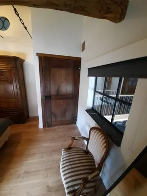a living room with a couch and a large window at Het Stalhuys in Riemst