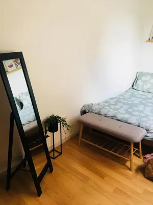 a bedroom with a bed and a mirror in it at Les charmilles in Chaudfontaine