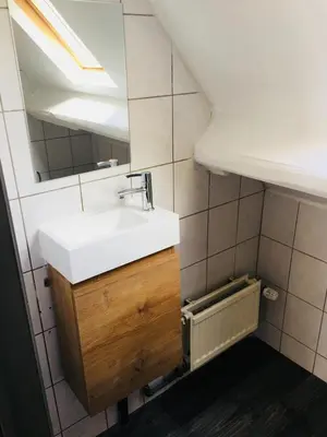 a bathroom with a sink and a mirror at Les charmilles in Chaudfontaine