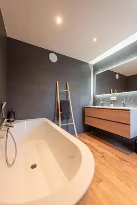 a large white tub in a bathroom with a sink at NEW - De sheeper - 10Personen - 5slaapkamers - Sauna - Jacuzzi in Riemst