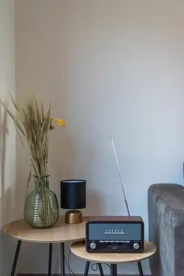 a table with a laptop and a vase on it at NEW - De sheeper - 10Personen - 5slaapkamers - Sauna - Jacuzzi in Riemst