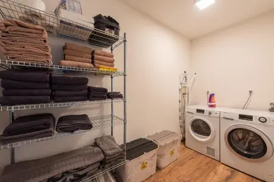 a laundry room with a washer and a washing machine at NEW - De sheeper - 10Personen - 5slaapkamers - Sauna - Jacuzzi in Riemst