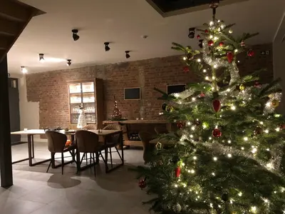 a christmas tree in a room with a dining room at B & B De Romeinse Katzei in Borgloon