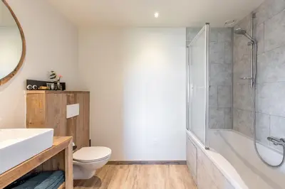 a bathroom with a tub and a toilet and a shower at Bed en Vrijheid in Peer