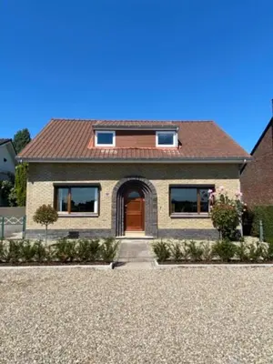 a house with a brown door and a gravel driveway at Maashuys in Lanaken