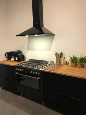 a kitchen with a black stove top oven at Maashuys in Lanaken