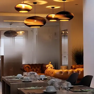 a dining room with a leather couch and a table at B&B Atuatuca in Tongeren