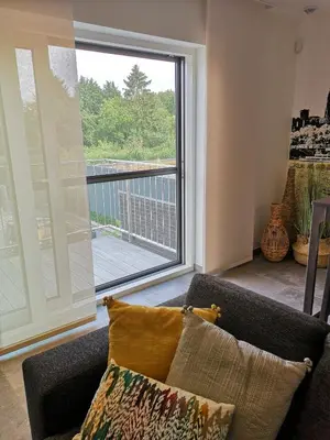 a living room with a large window and a couch at Vakantiewoning Atuatuca in Tongeren