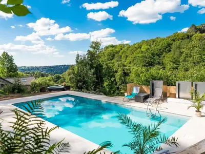 a swimming pool with a view of the trees at Holiday home with sauna and swimming pool in Verviers