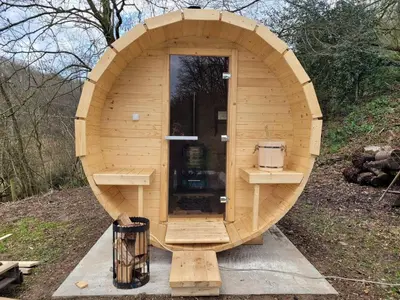 a small wooden sauna with a door in the middle at Holiday home with sauna and swimming pool in Verviers