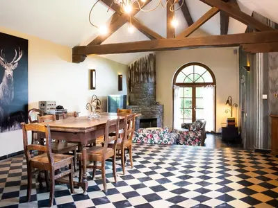 a dining room with a table and chairs at Holiday home with sauna and swimming pool in Verviers