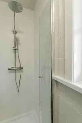 a shower in a bathroom with a glass door at Vakantiewoning De zandberg in Pelt