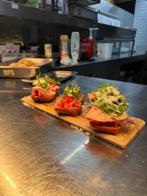 a counter with three sandwiches on a cutting board at Hof van Stayen in Sint-Truiden