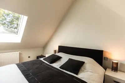 a bedroom with a bed with two pillows on it at Kolisheide in Peer