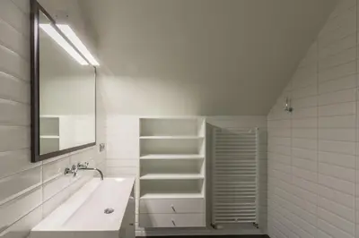 a white bathroom with a sink and a mirror at Kolisheide in Peer