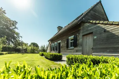 a wooden house with a yard in front of it at Kolisheide in Peer