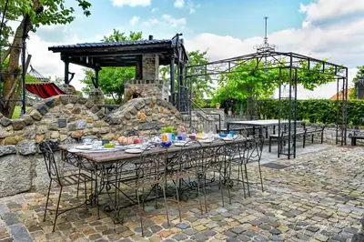 a table and chairs with a roller coaster in the background at Landhaus Lontzen in Lontzen