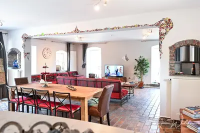 a living room with a table and chairs and a couch at Landhaus Lontzen in Lontzen