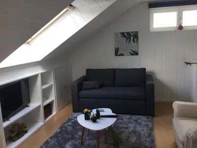 a living room with a couch and a table at De achtertuin in Maasmechelen