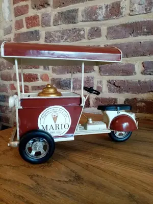 a red and white cart sitting on a wooden floor at Logies Mario in Tongeren