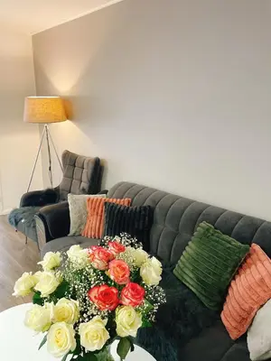 a living room with a couch with flowers on a table at VIP 67 in Eupen