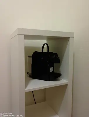 a black bag sitting on a shelf in a room at Logement Régence in Liège