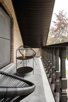 a patio with a table and a bench on a building at 't Wilgenhuys in Lommel