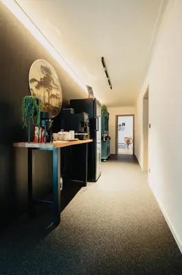 a kitchen with a table and a refrigerator at 't Wilgenhuys in Lommel