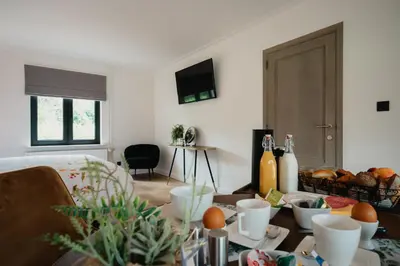a living room with a table with food on it at 't Wilgenhuys in Lommel