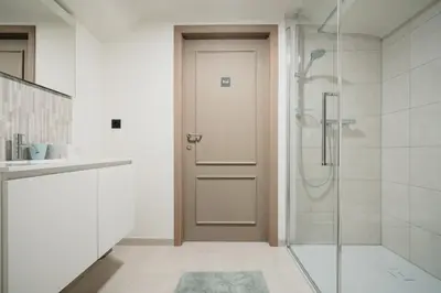a bathroom with a shower and a glass door at 't Wilgenhuys in Lommel