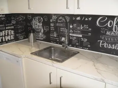 a kitchen counter with a sink and a chalkboard wall at Liège centre 6 rue montagne sainte Walburge, 4000 Liège, pour 2 pers à 3 minutes de la gare st Lambert in Liège