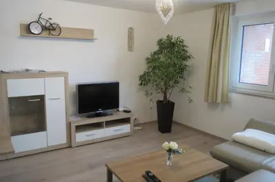 a living room with a tv and a couch at Chalet M in Eupen