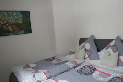 a bedroom with two beds and a painting on the wall at Chalet M in Eupen
