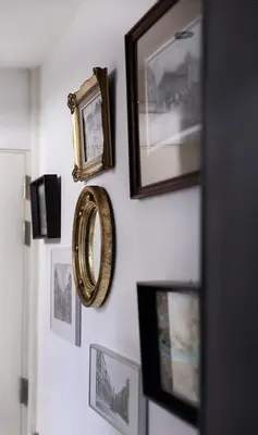 a room with pictures and a mirror on a wall at GITADIN - Deluxe Suite Rousseau - Historical center in Liège