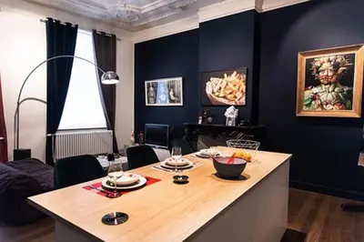 a living room with a table with food on it at GITADIN - Deluxe Suite Rousseau - Historical center in Liège