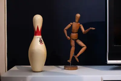 a wooden doll and a vase on a table at GITADIN - Deluxe Suite Rousseau - Historical center in Liège