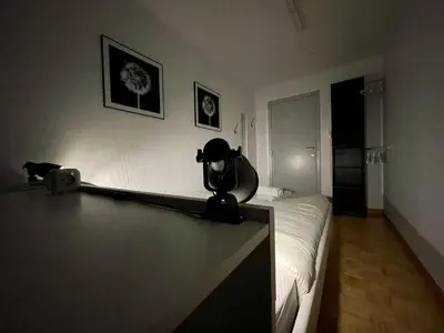 a room with a bed with a camera on a table at Villa Domus XIX in Tongeren