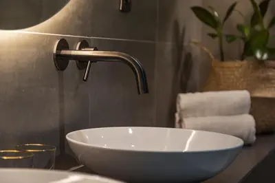 a bathroom with a white sink and a faucet at Bed & Breakfast Nummer5 in Heusden - Zolder