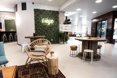 a store with tables and chairs in a room at HI Liège Hostel in Liège
