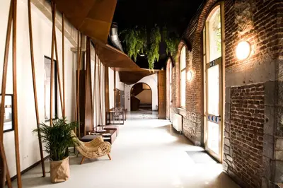 an empty alley with a bench and a building at HI Liège Hostel in Liège