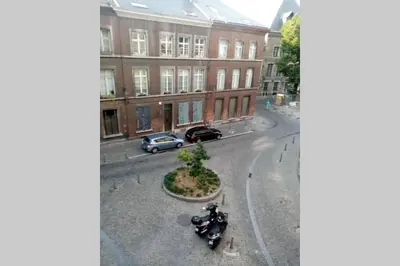 a view of a street with motorcycles parked on the street at Studio donceel in Liège